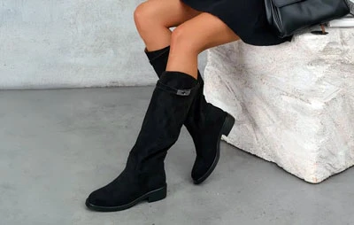 Чёрные женские замшевые сапоги до колена на низком ходу, вид сбоку